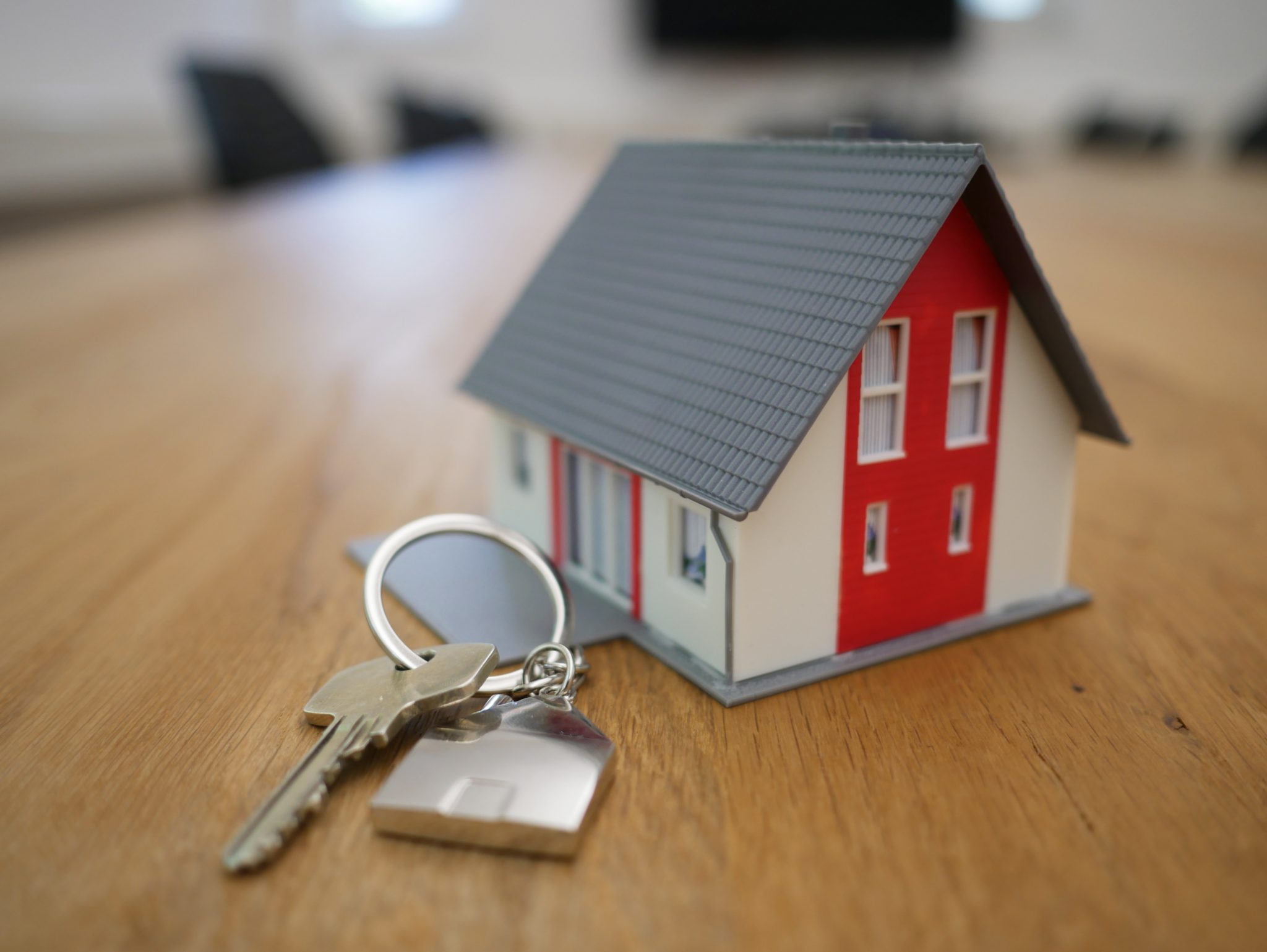 a keychain house with key on a table
